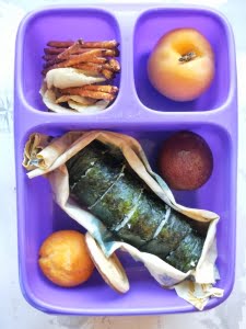 Healthy kids lunchbox with sushi and fruit